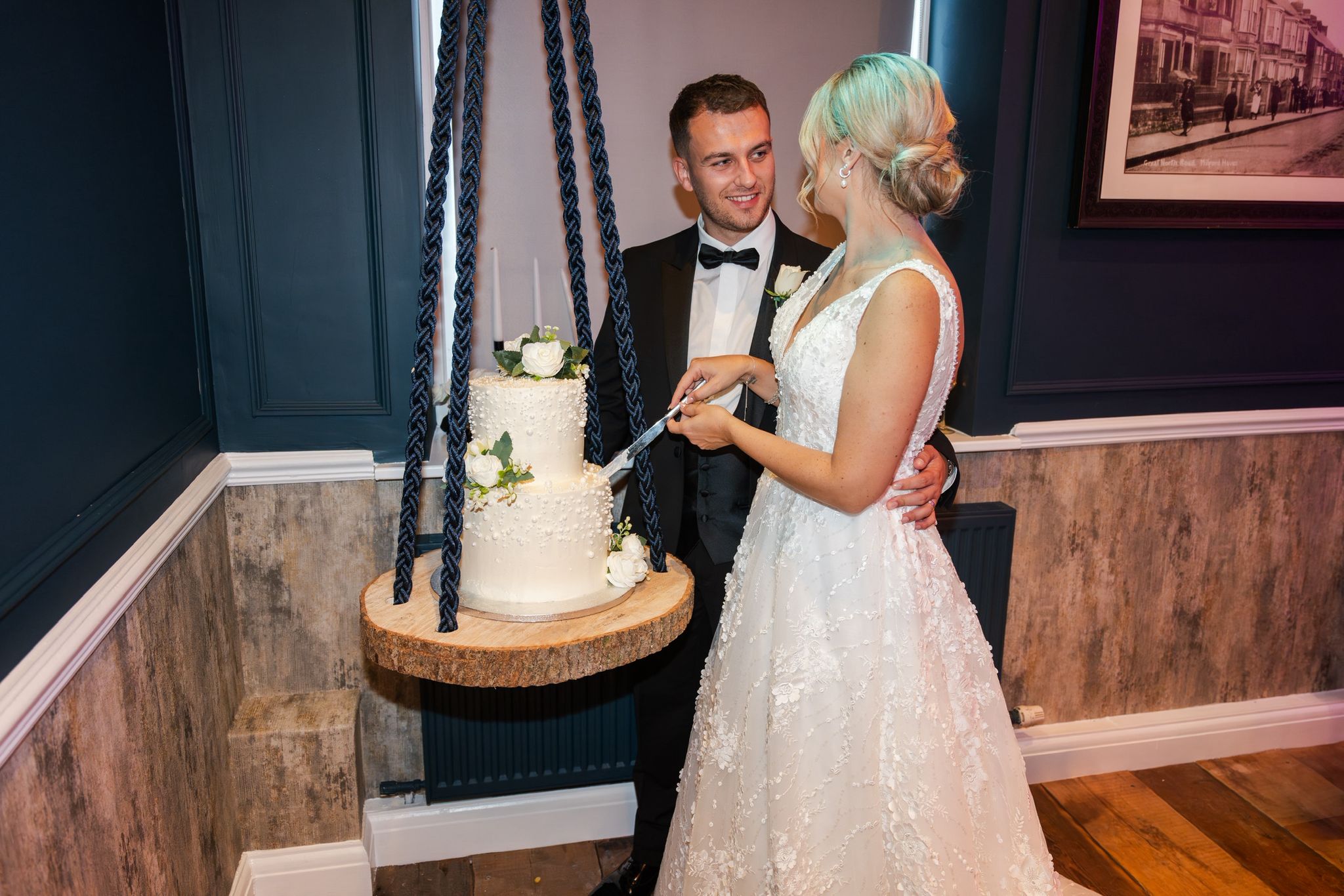 Couple cutting wedding cake
