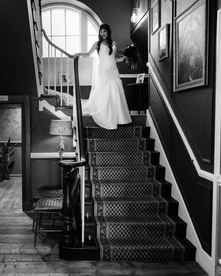 Bride in wedding dress on stairs